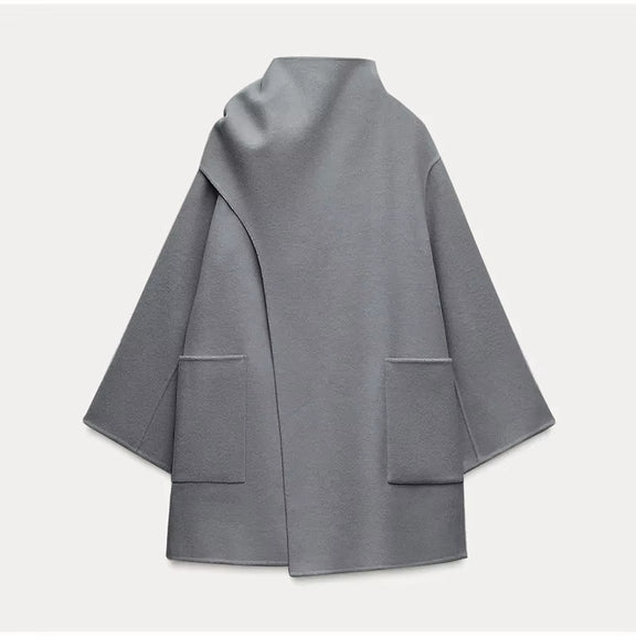 Fashionable grey women's winter coat featuring a single-breasted closure and lapel collar