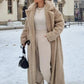 Model wearing a chic faux fur coat, showcasing its classic silhouette.