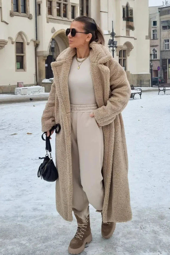 Model wearing a chic faux fur coat, showcasing its classic silhouette.