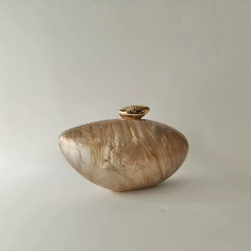 Elegant hard case clutch in pearl brown marble acrylic with gold-toned clasp and decorative bead handle