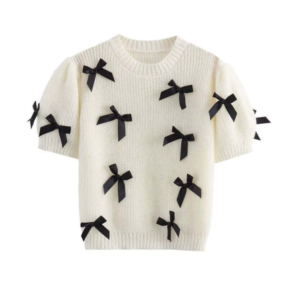 Loose-fit sweater with geometric pattern and decorative bow for women.