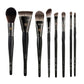 Makeup brush with an elegant design featuring a wooden handle and high-quality hairs for perfect makeup applications. Ideal for blusher, concealer, and eyeshadow.