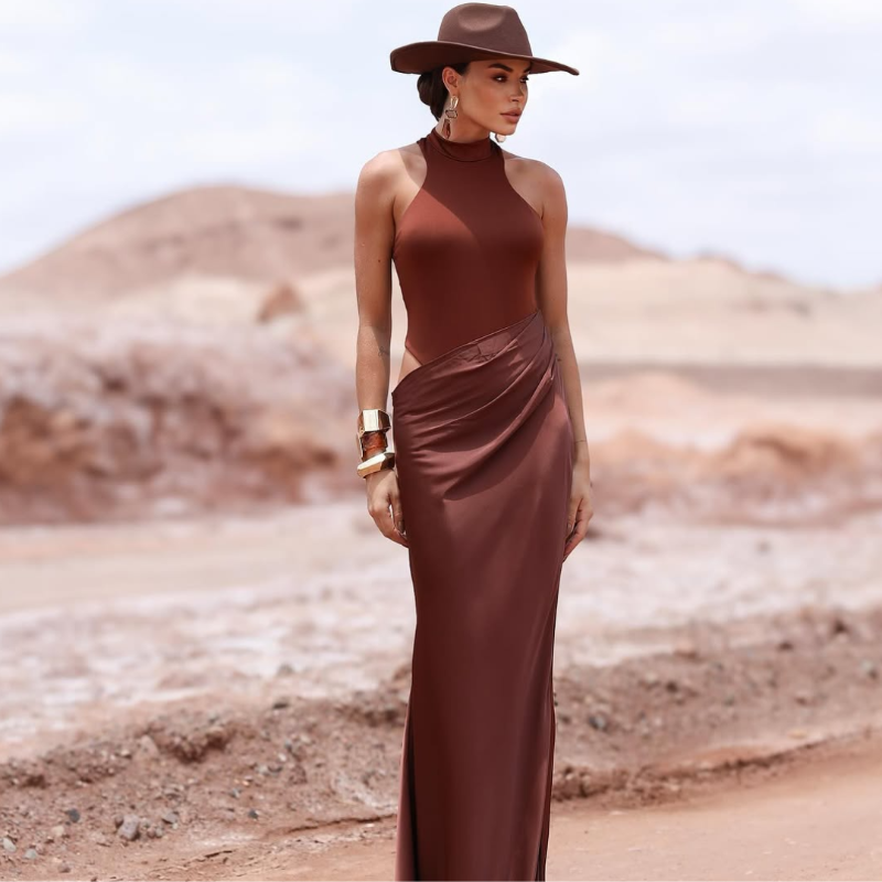 Malta Elegant off-shoulder long dress in brown with a flowing plisse silhouette and feminine ruffle hem.