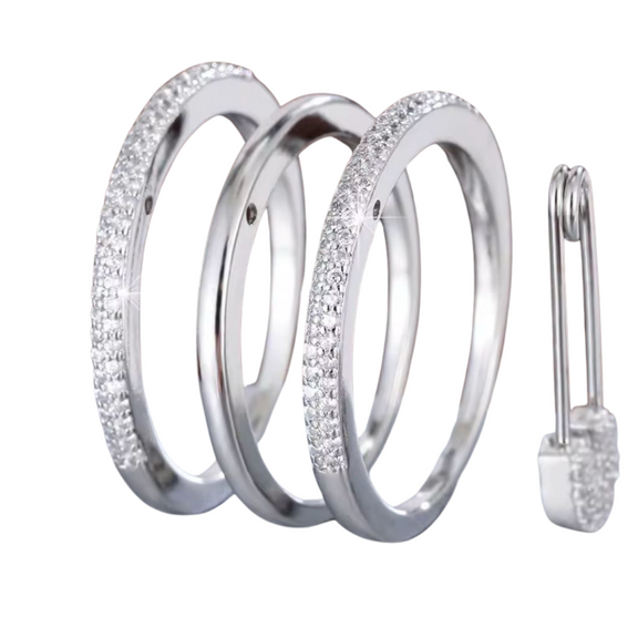 Stacked silver rings with dazzling crystals and a unique safety pin lock