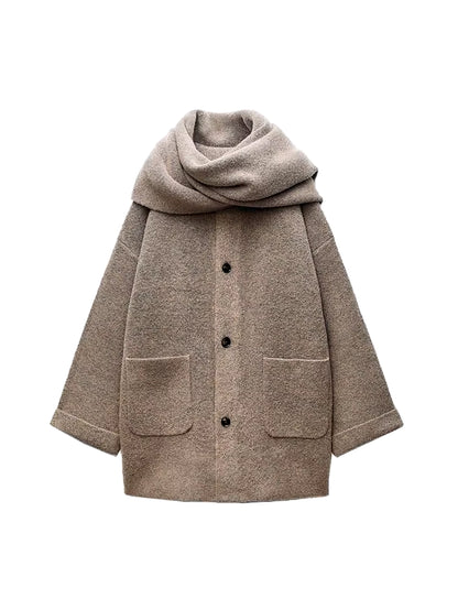 Elegant beige wool blend coat with attached scarf, single-breasted design and oversized silhouette for fall winter 2025.