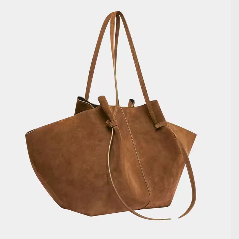 Side and detail view of Milano Luxe Suede Tote in rich brown vegan suede, showcasing stitching and knot handle design

