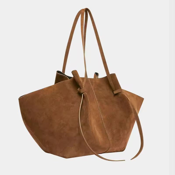 Side and detail view of Milano Luxe Suede Tote in rich brown vegan suede, showcasing stitching and knot handle design
