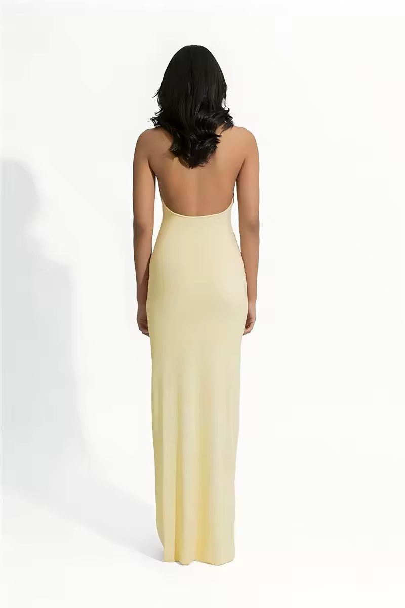 Noa yellow halter dress 2025 – floor-length backless gown with ruffle neckline, A-line silhouette, soft stretch polyester-spandex fabric. Elegant summer outfit for beach weddings, club nights, luxury vacations & golden hour events.