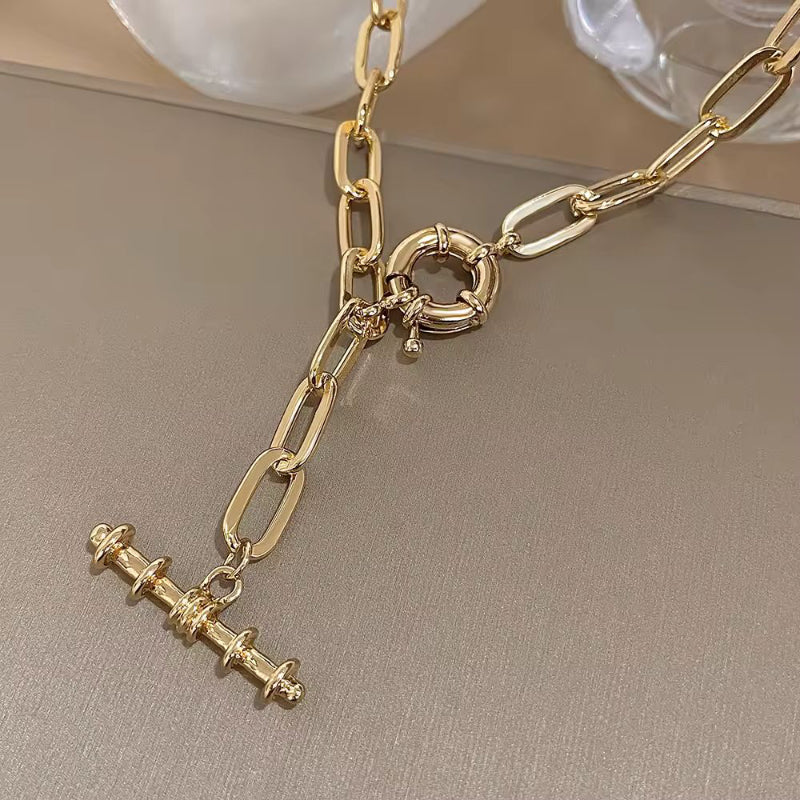 Close-up of Nova Luxe necklace showing gold-plated metal and modern chain design