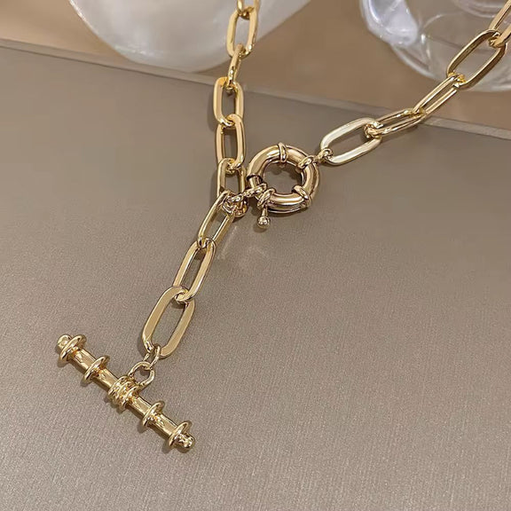 Close-up of Nova Luxe necklace showing gold-plated metal and modern chain design