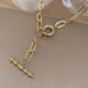Close-up of Nova Luxe necklace showing gold-plated metal and modern chain design