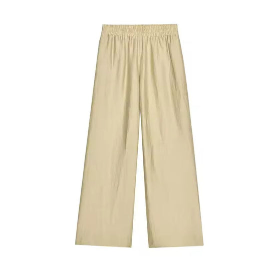Beige spring/summer outfit – relaxed wide leg pants with tie waist shirt, perfect for travel
