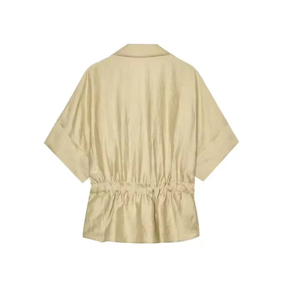 Beige spring/summer outfit – relaxed wide leg pants with tie waist shirt, perfect for travel
