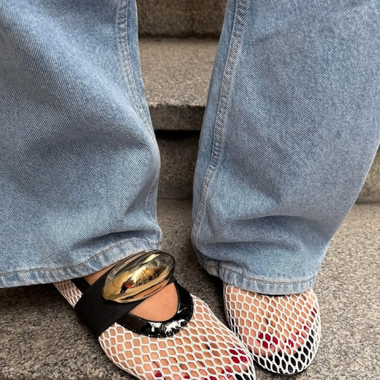 Women’s mesh loafers in white and black with gold accent. Flat, breathable summer shoes with slip-on comfort and stylish luxury detail.