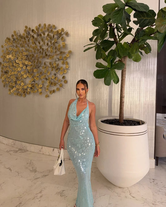 Elegant sequin maxi dress with waterfall neckline and open back, Formentera-inspired summer gown.
