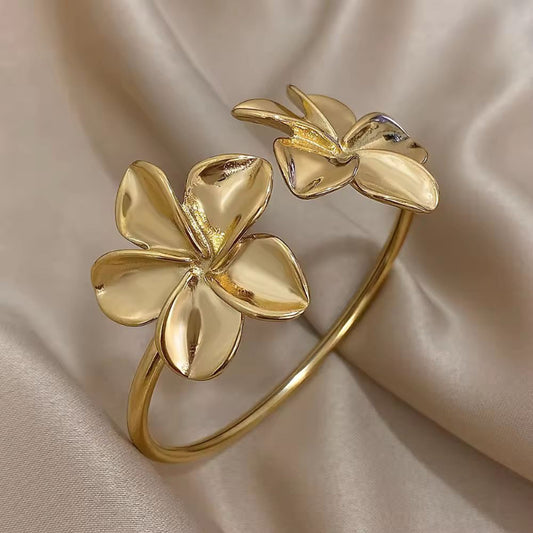 Gold waterproof floral cuff bracelet for women with sculpted flower ends – stainless steel elegant jewelry piece
