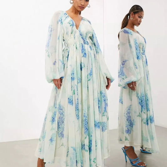 Model wearing lightweight chiffon dress with pastel flower print, long balloon sleeves and stretch waist
