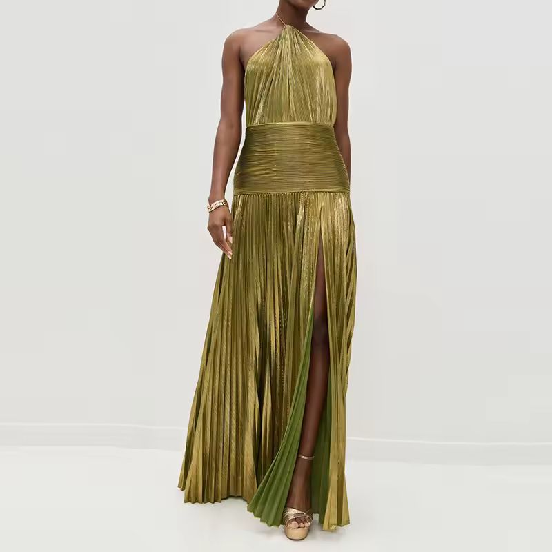Model wearing a shimmering gold-olive pleated halter neck maxi dress with high slit and ruched waistband, styled with gold jewelry and platform heels – front view.