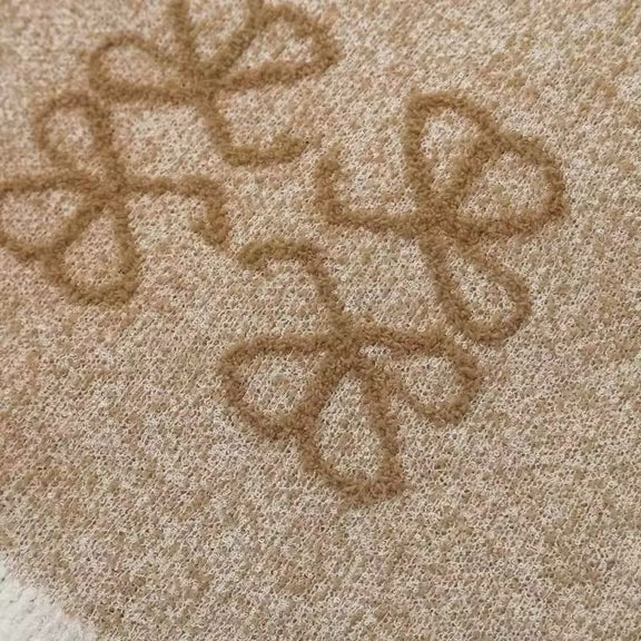 Close-up of jacquard texture and soft knit fabric – feminine vintage-style sweater vest
