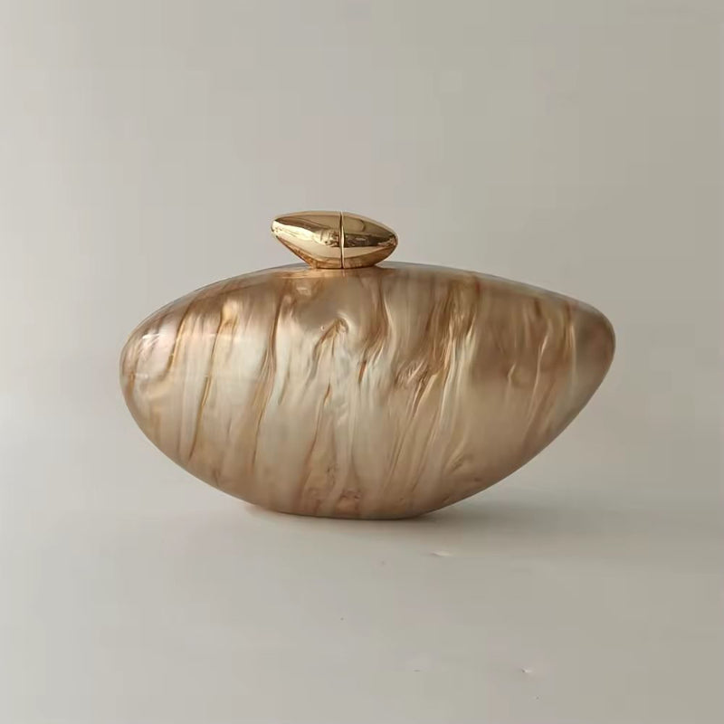 Luxury golden shell acrylic clutch bag with marble pearl finish and gold chain for evening wear and weddings.