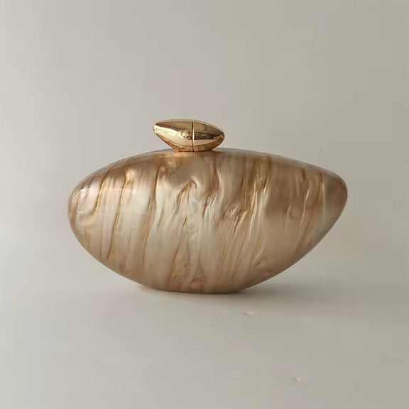 Luxury golden shell acrylic clutch bag with marble pearl finish and gold chain for evening wear and weddings.