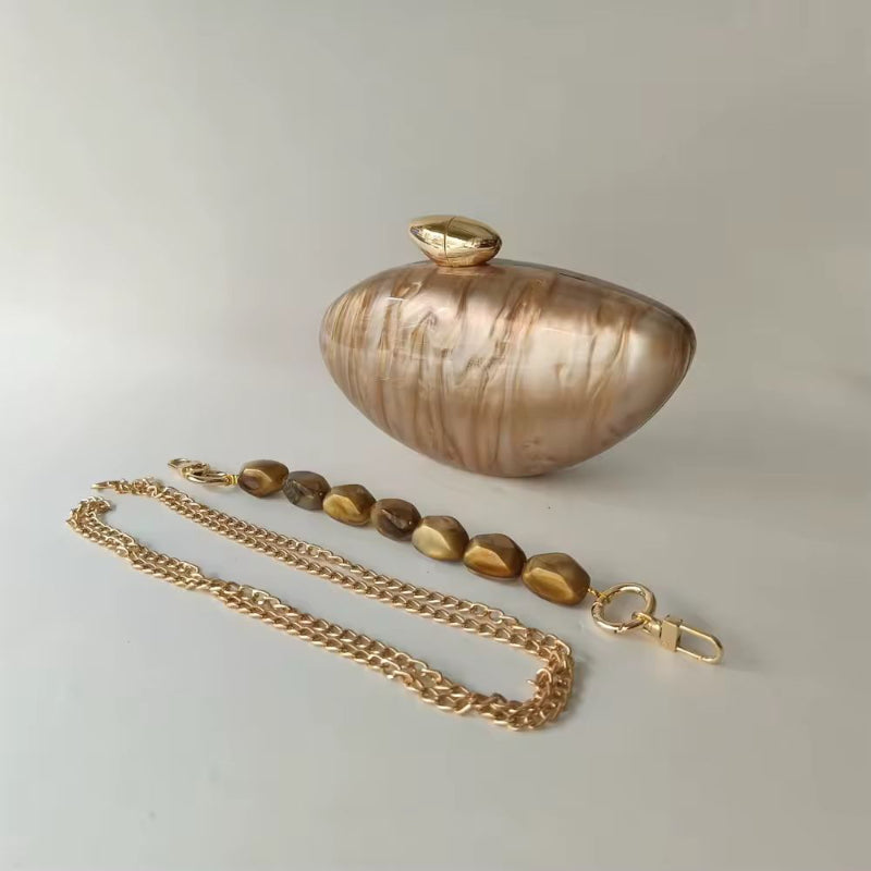 Elegant hard case clutch in pearl brown marble acrylic with gold-toned clasp and decorative bead handle