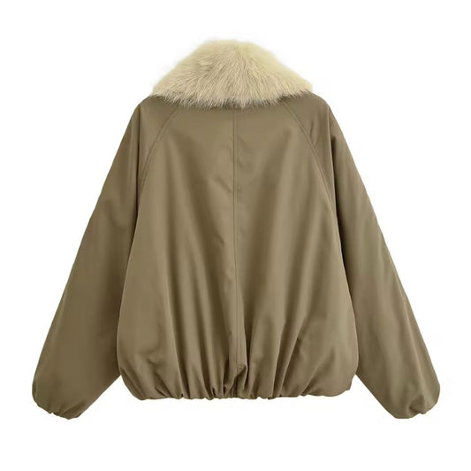 Oversized khaki bomber jacket with ivory faux fur collar – cozy winter fashion for women.

