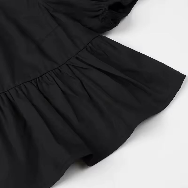 Black tie-front summer blouse with puff sleeves and soft flared hem, trendy and bold casual wear for women.