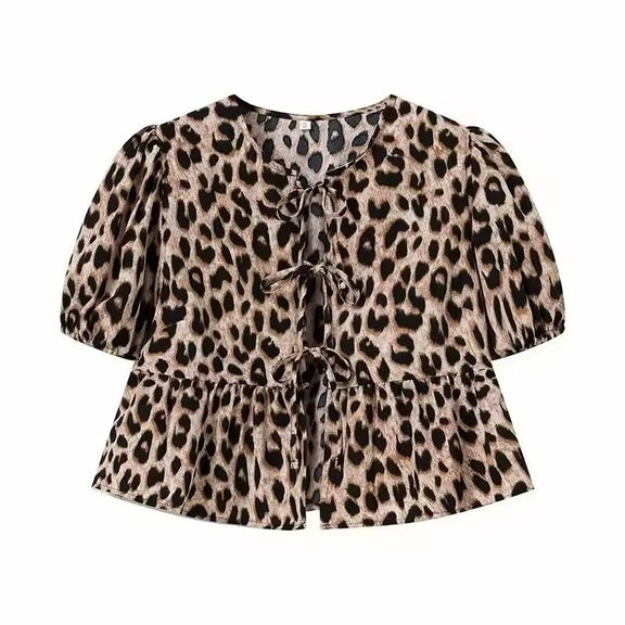 Leopard print tie-front summer blouse with puff sleeves and soft flared hem, trendy and bold casual wear for women.