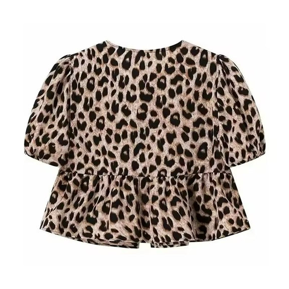 Leopard print tie-front summer blouse with puff sleeves and soft flared hem, trendy and bold casual wear for women.