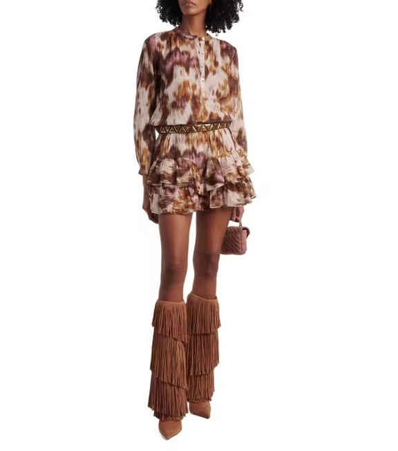 Model wearing CAVALLA Western fringe boots with printed dress – trendy fall winter 2025 outfit.
