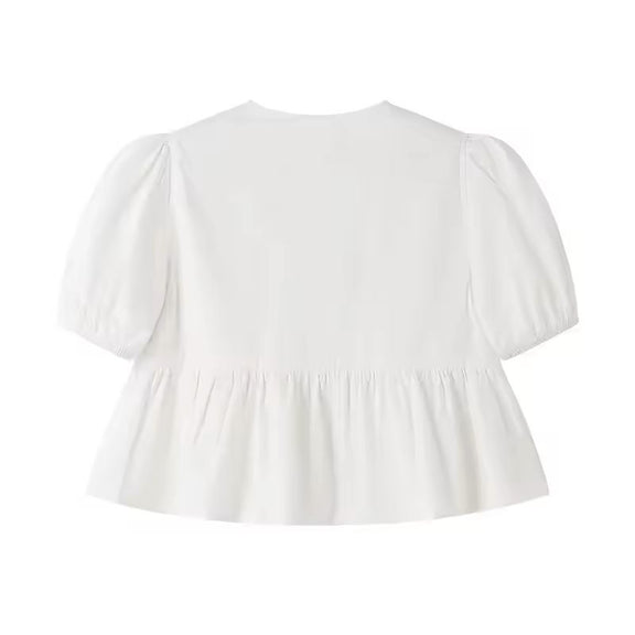 Lightweight white puff sleeve tie-front blouse with round neckline and relaxed fit, perfect for summer outfits.

