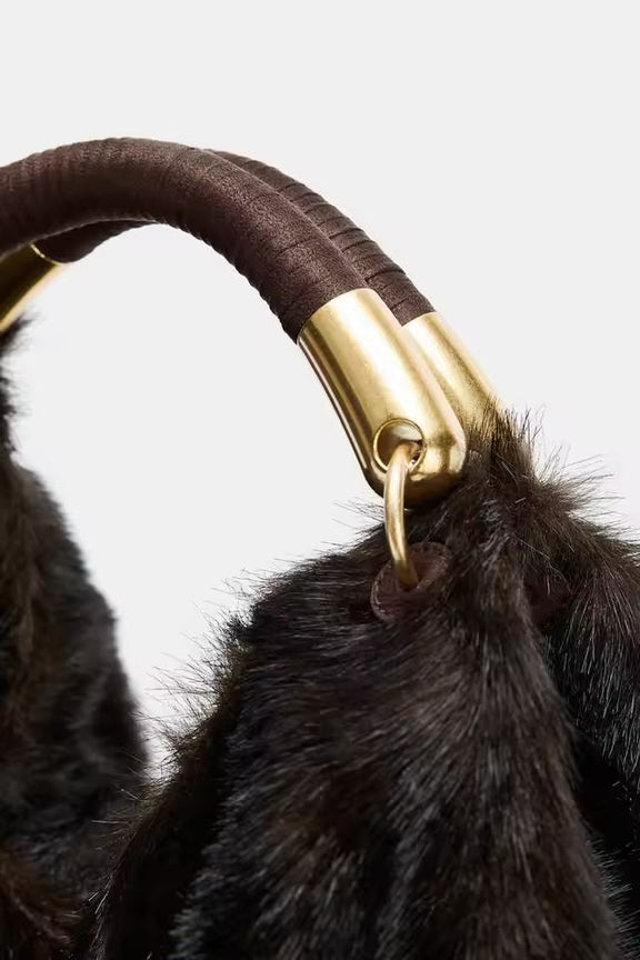 Elegant plush winter handbag in chocolate brown faux fur with gold metal details, perfect fall and winter fashion accessory.
