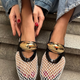 Women’s mesh loafers in white and black with gold accent. Flat, breathable summer shoes with slip-on comfort and stylish luxury detail.