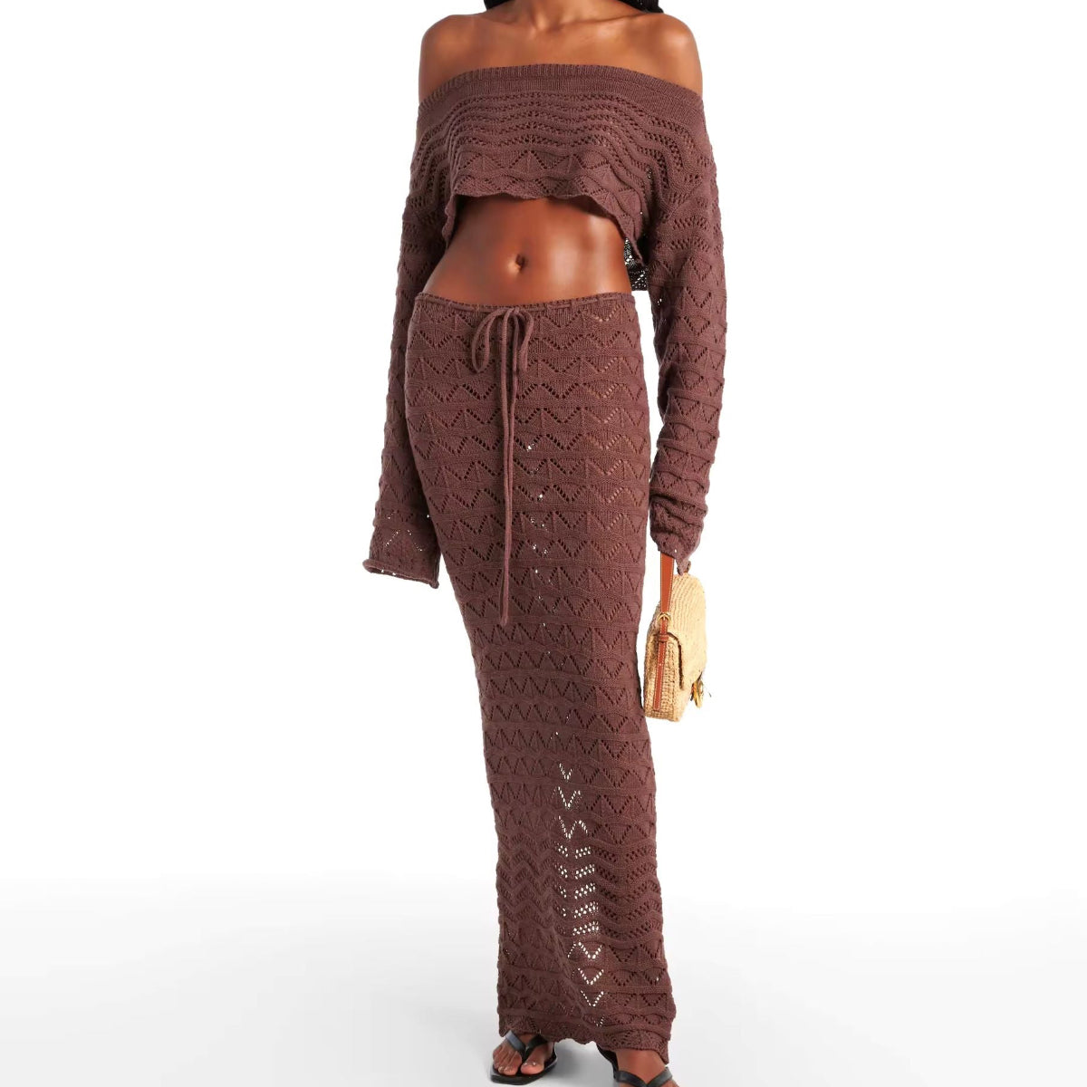 Two-piece Sahara Boho crochet outfit for women in white and brown, featuring an off-shoulder long sleeve crop top and high-waisted maxi skirt with drawstring, perfect for beachwear, festivals, and summer vacations