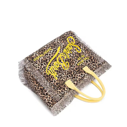 Extra-large Saint Barth canvas beach bag for women with boho fringe and summer script, oversized and handcrafted look.
