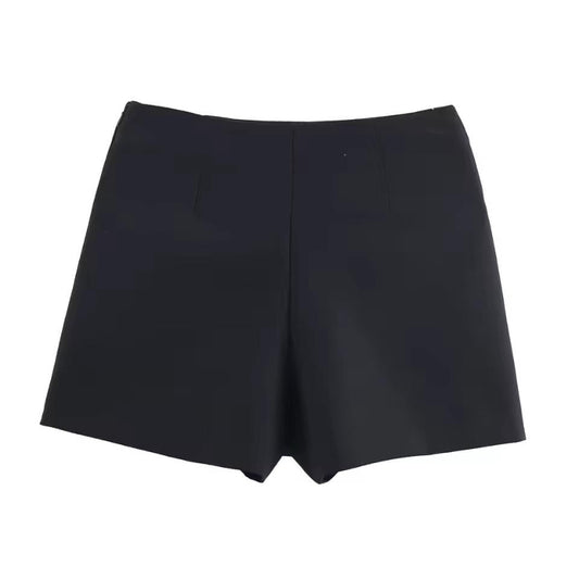 Black high-waist wrap mini skirt with metallic accent – minimalist autumn fashion.
