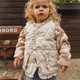 Piper Ruffle Vest for Girls by Chic Charm, stylish beige and brown kids’ vest with ruffle trims, functional front pockets, and snap buttons, made from 95% cotton and 5% polyester for comfort, warmth, and versatility, perfect for layering year-round.