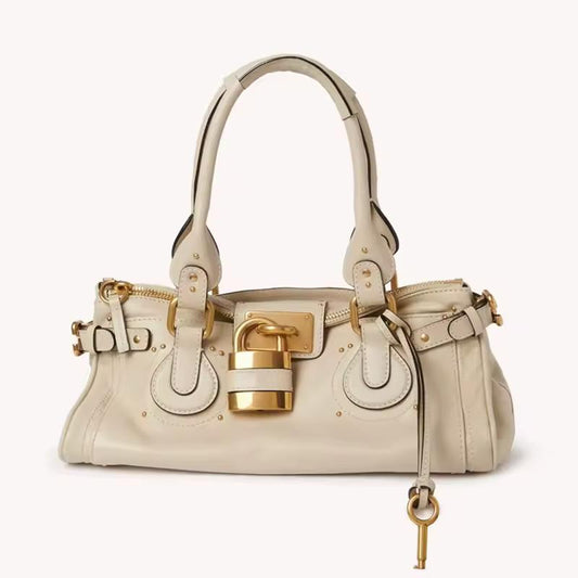 Cream soft PU leather handbag with gold hardware and top handles – The CHARM LOCK Bag, timeless and chic.