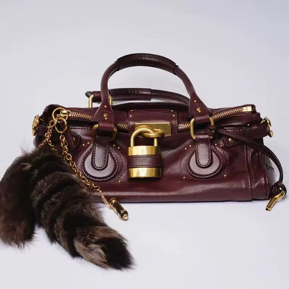 Wine red PU leather satchel with gold padlock and elegant soft texture – The CHARM LOCK Bag, Chic & Charm.

