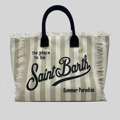 Extra-large Saint Barth canvas beach bag for women with boho fringe and summer script, oversized and handcrafted look.
