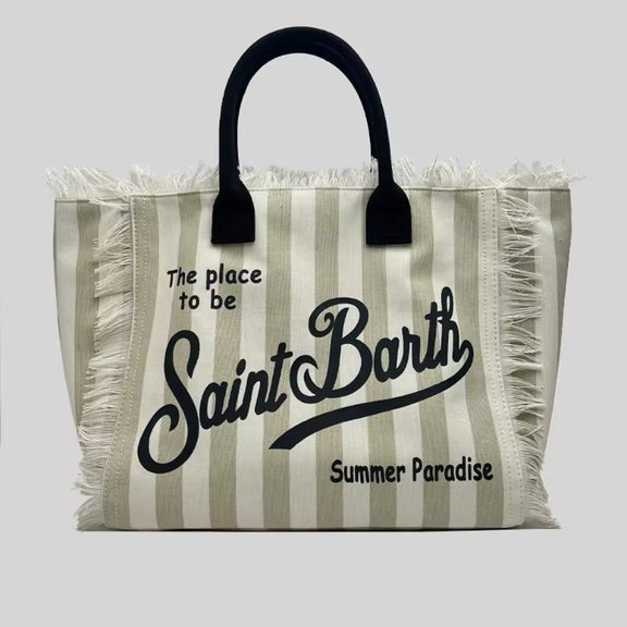 Extra-large Saint Barth canvas beach bag for women with boho fringe and summer script, oversized and handcrafted look.
