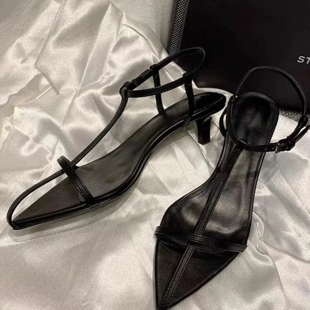 Trendy monochrome pointed-toe sandals with low heel and comfortable ankle strap for any outfit.