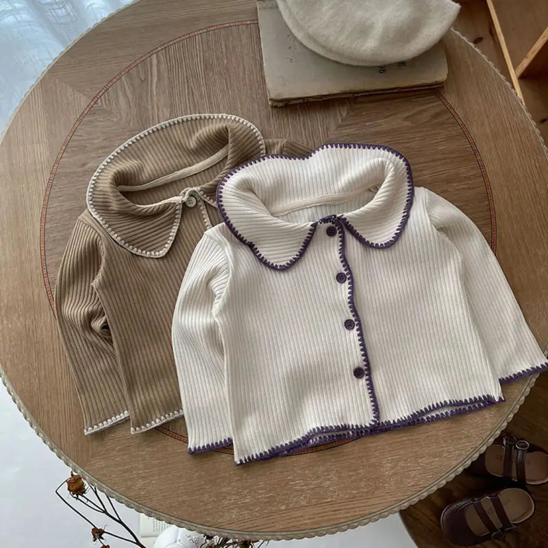 Chic Charm two-piece baby set with ruffles, made from 100% cotton, featuring a button closure and delicate ruffle details on sleeves and hem. Comfortable and stylish baby clothes for everyday wear or special occasions.