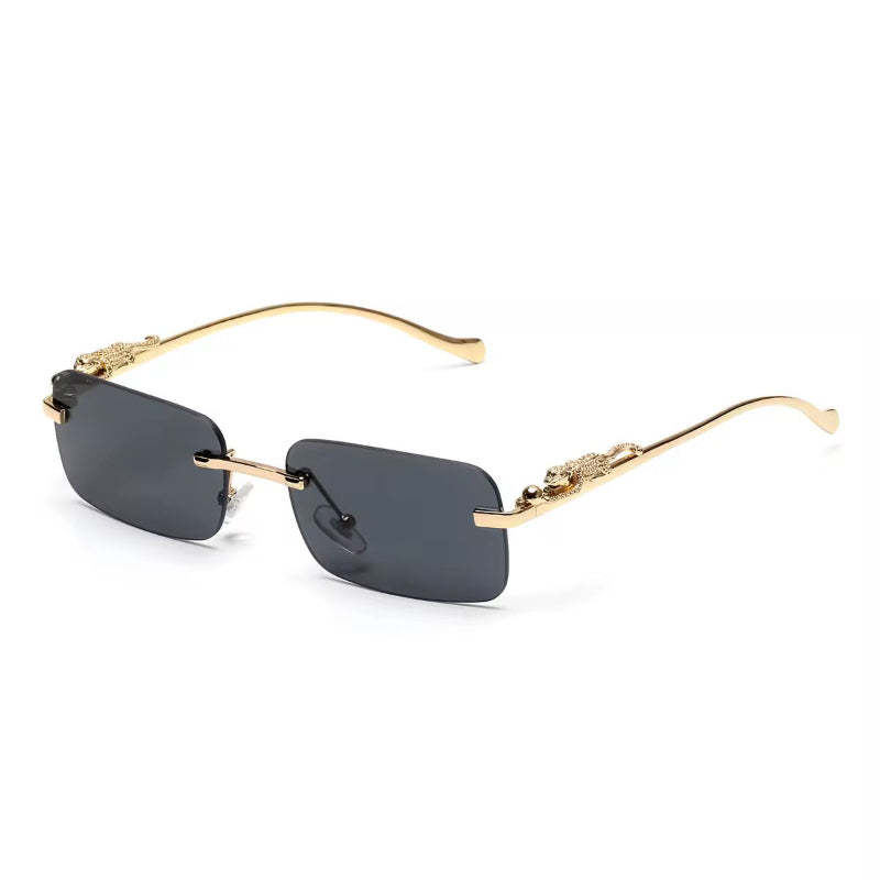 Rimless UV400 sunglasses with dark grey gradient lenses and gold panther detail
