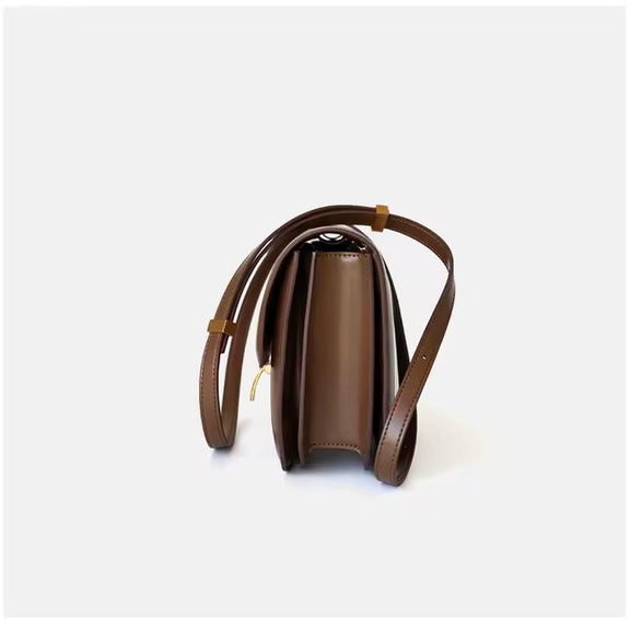 Classic cognac brown leather shoulder bag with gold clasp and soft texture — warm-toned minimalist leather accessory for fall and winter.
