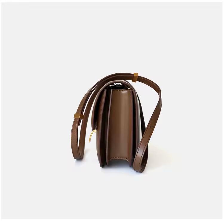 Classic cognac brown leather shoulder bag with gold clasp and soft texture — warm-toned minimalist leather accessory for fall and winter.
