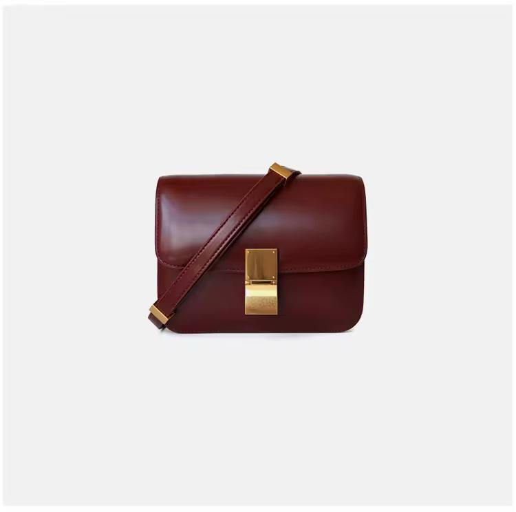 Elegant burgundy genuine leather shoulder bag with gold clasp and adjustable strap — timeless minimalist handbag for everyday wear.
