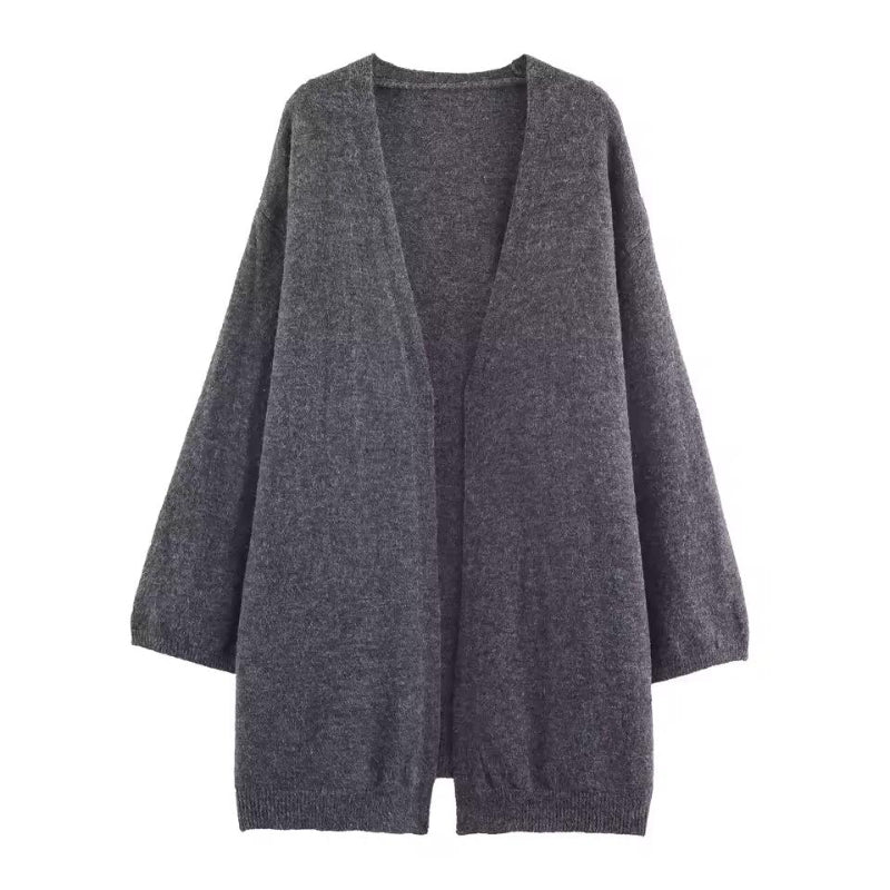 Soft knit cardigan with delicate texture and button detail – luxury women’s knitwear in neutral tones.
