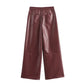 Wide-cut burgundy pants made from vegan leather, featuring practical pockets and luxury texture.